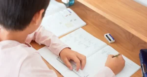 Criança organiza materiais e tarefas durante os estudos em casa